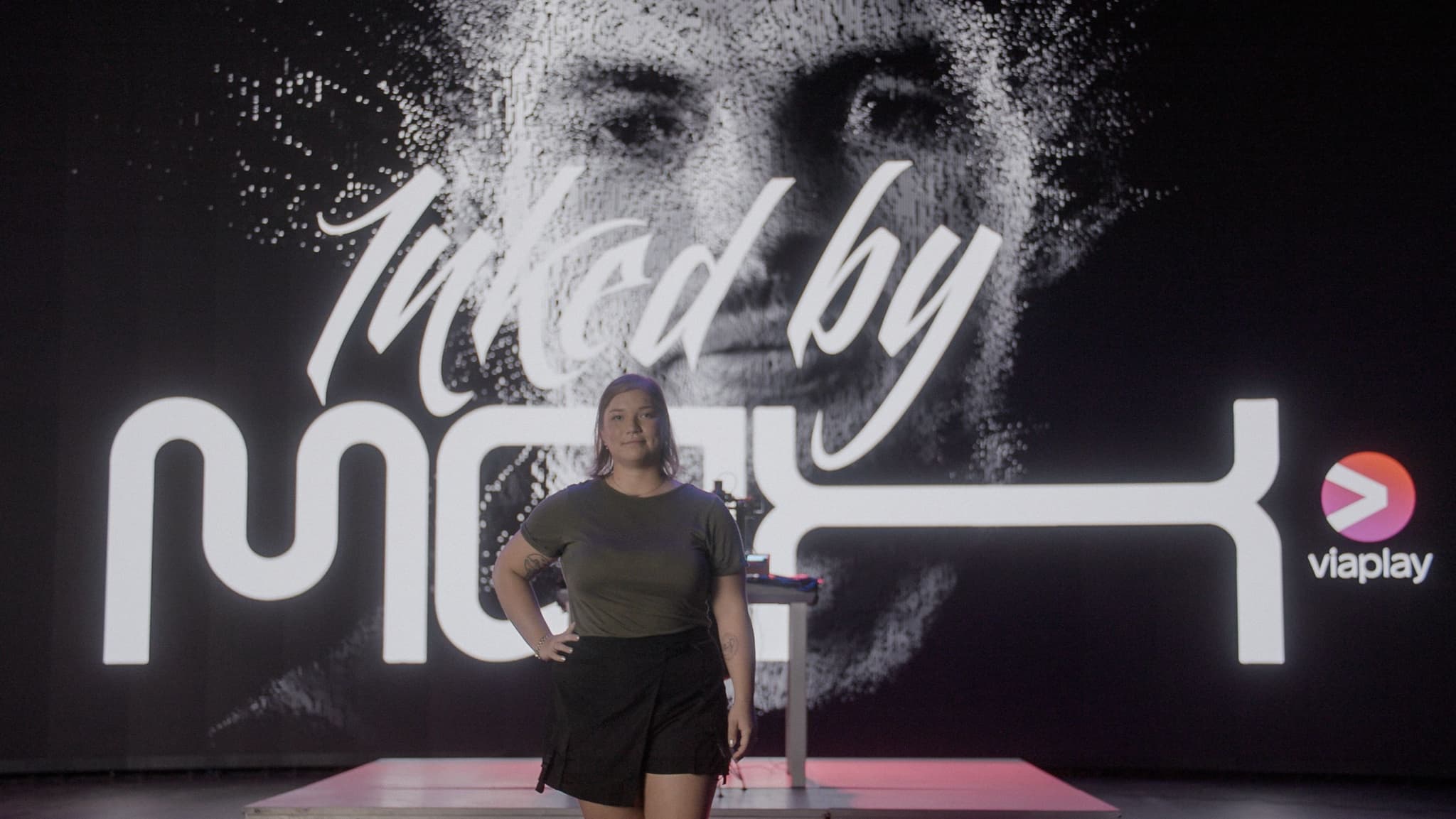 A photo of Carmen the superfan standing in front of Max Verstappen's image